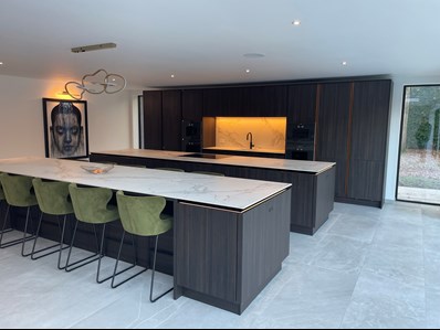 modern kitchen area with multiple islands and seating